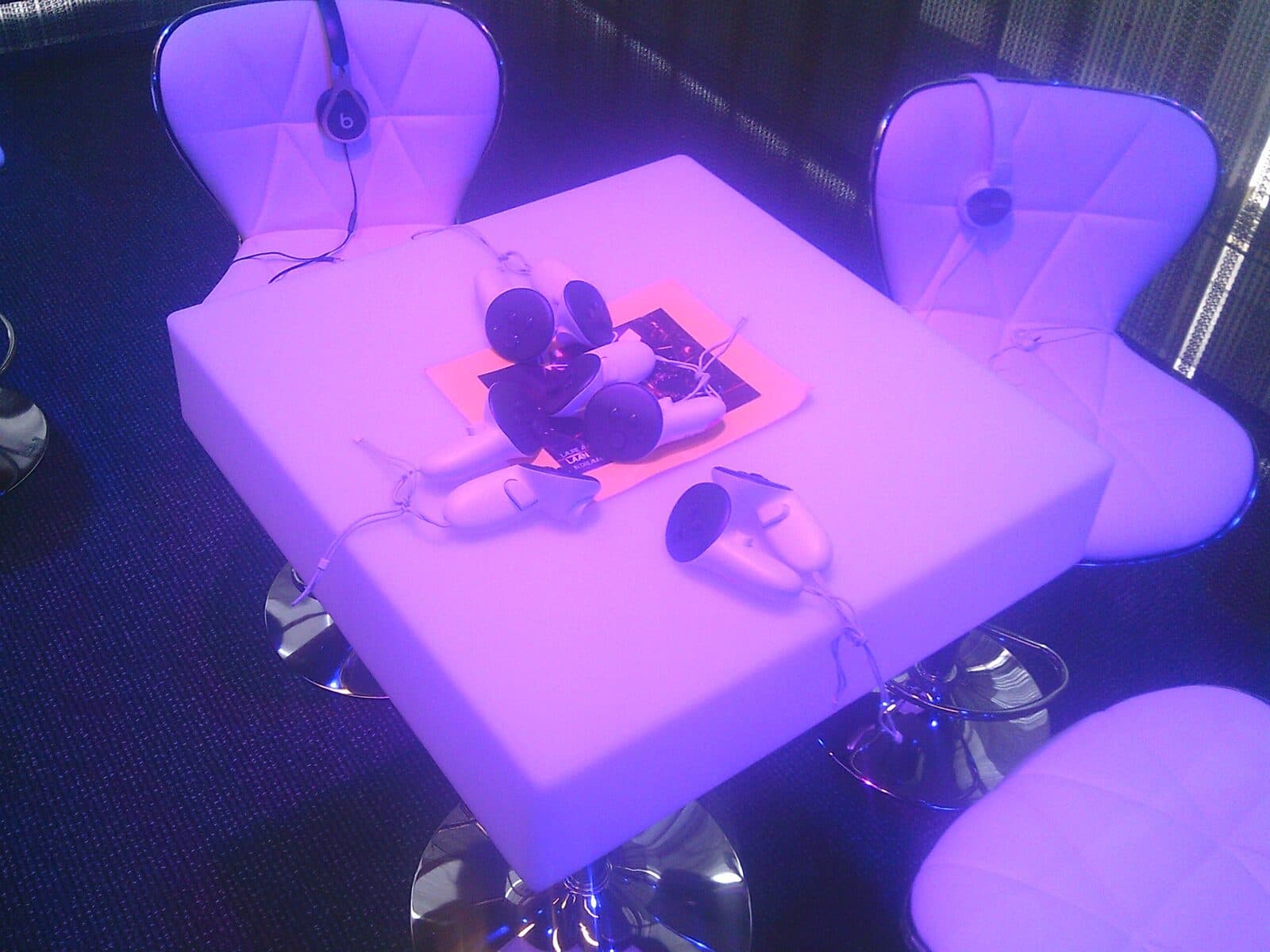 Close-up of VR controllers and headset resting on a lit table