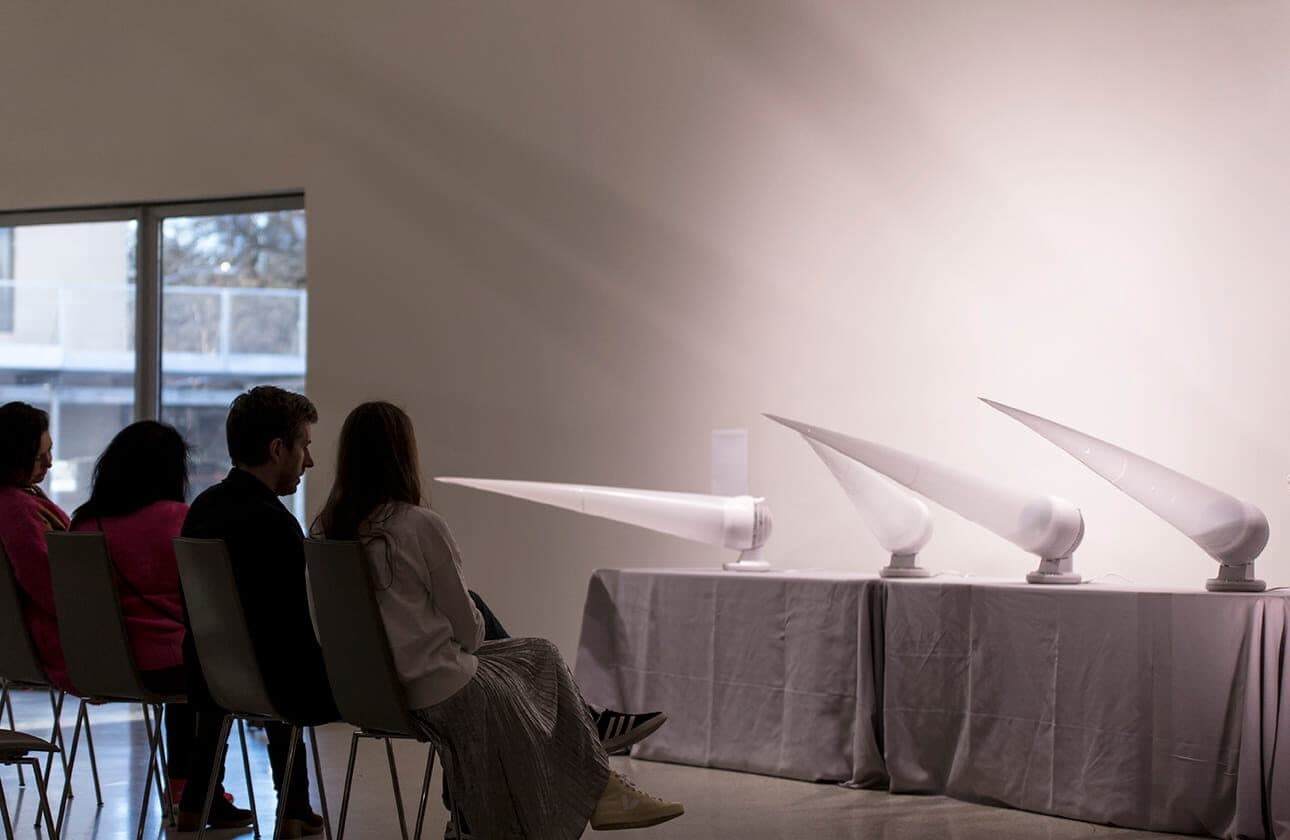 Visitors seated, viewing the installation